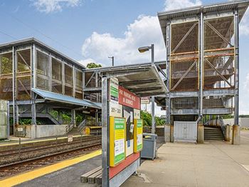 a train station with two platforms and a platform with a sign on it  at Residences at Westborough Station, Westborough, MA, 01581